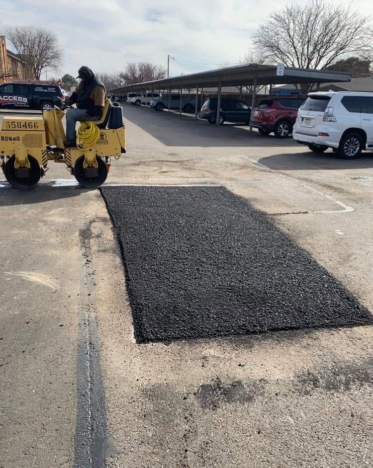 Freshly patched section of asphalt being rolled