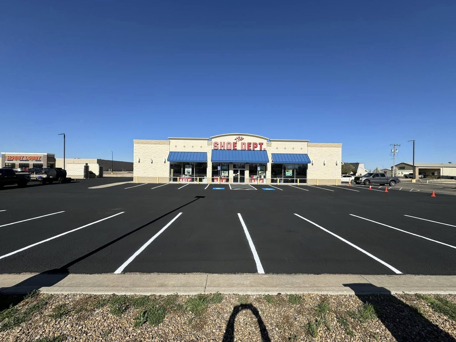 Freshly sealcoated and striped retail strip mall parking lot