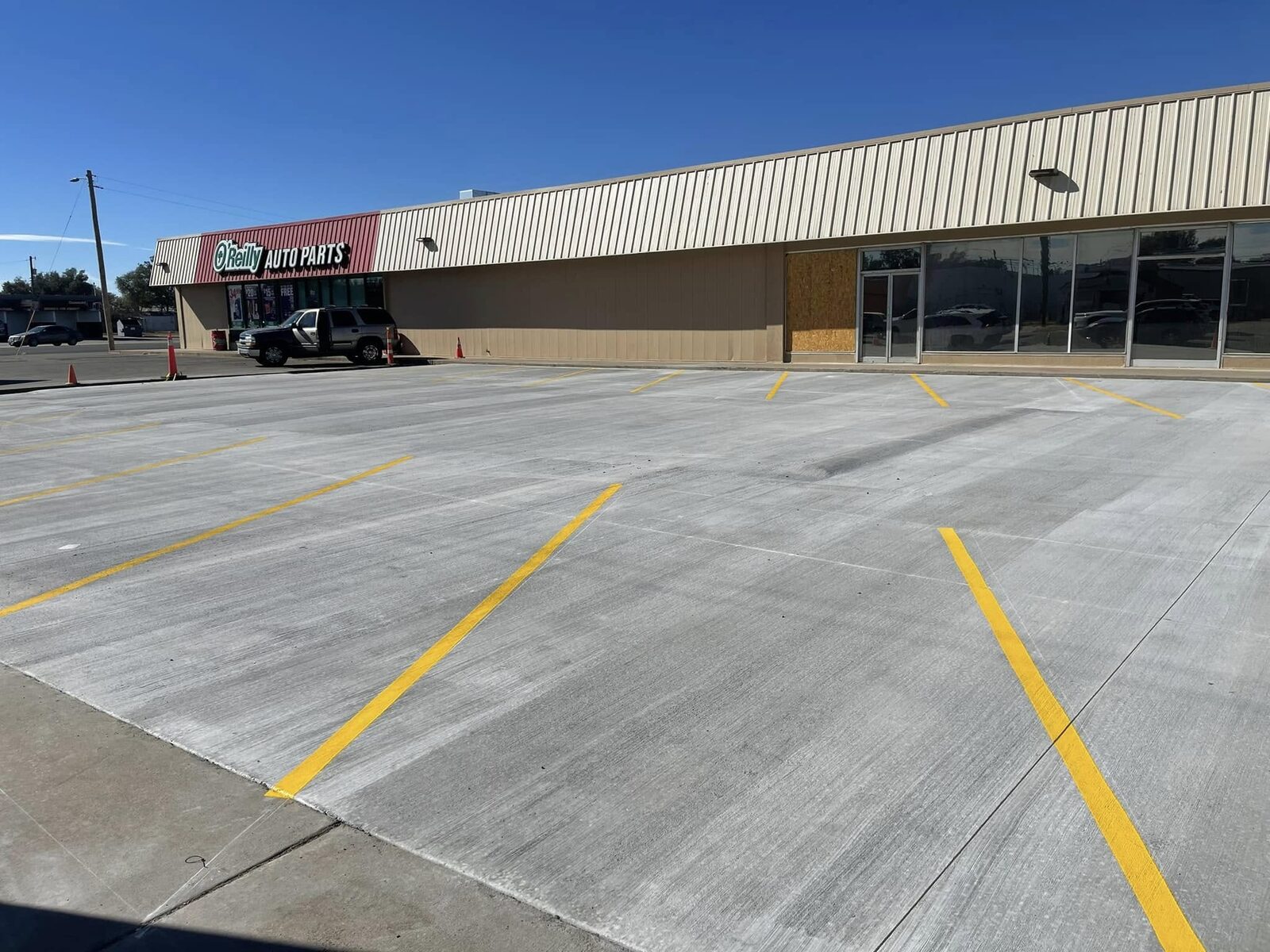 New concrete parking lot outside O'Reilly Auto Parts