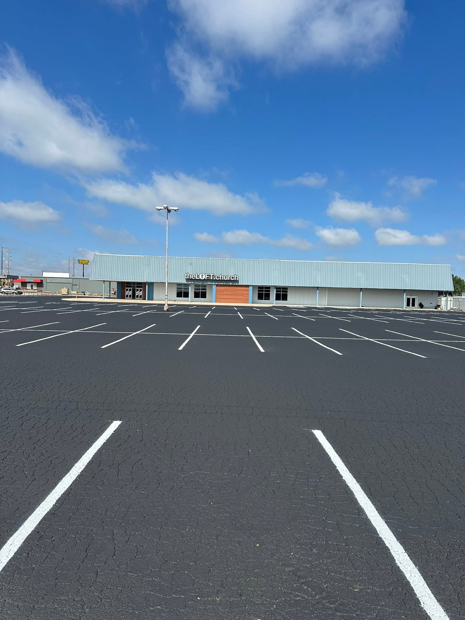 Freshly sealcoated and striped parking lot at theLOFT.church in Amarillo